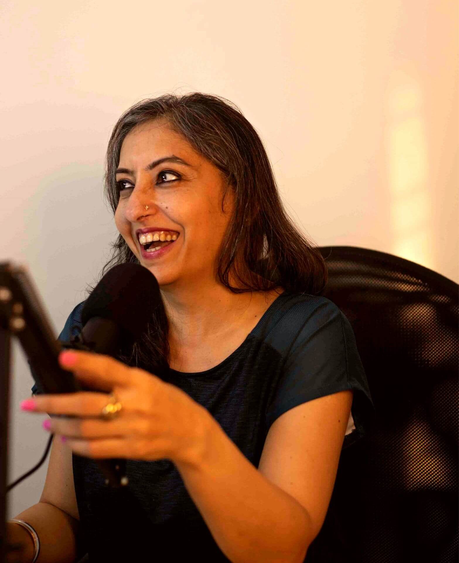 Homecoming Podcast by Manpreet Kaur Promotion Image Holding The Mic